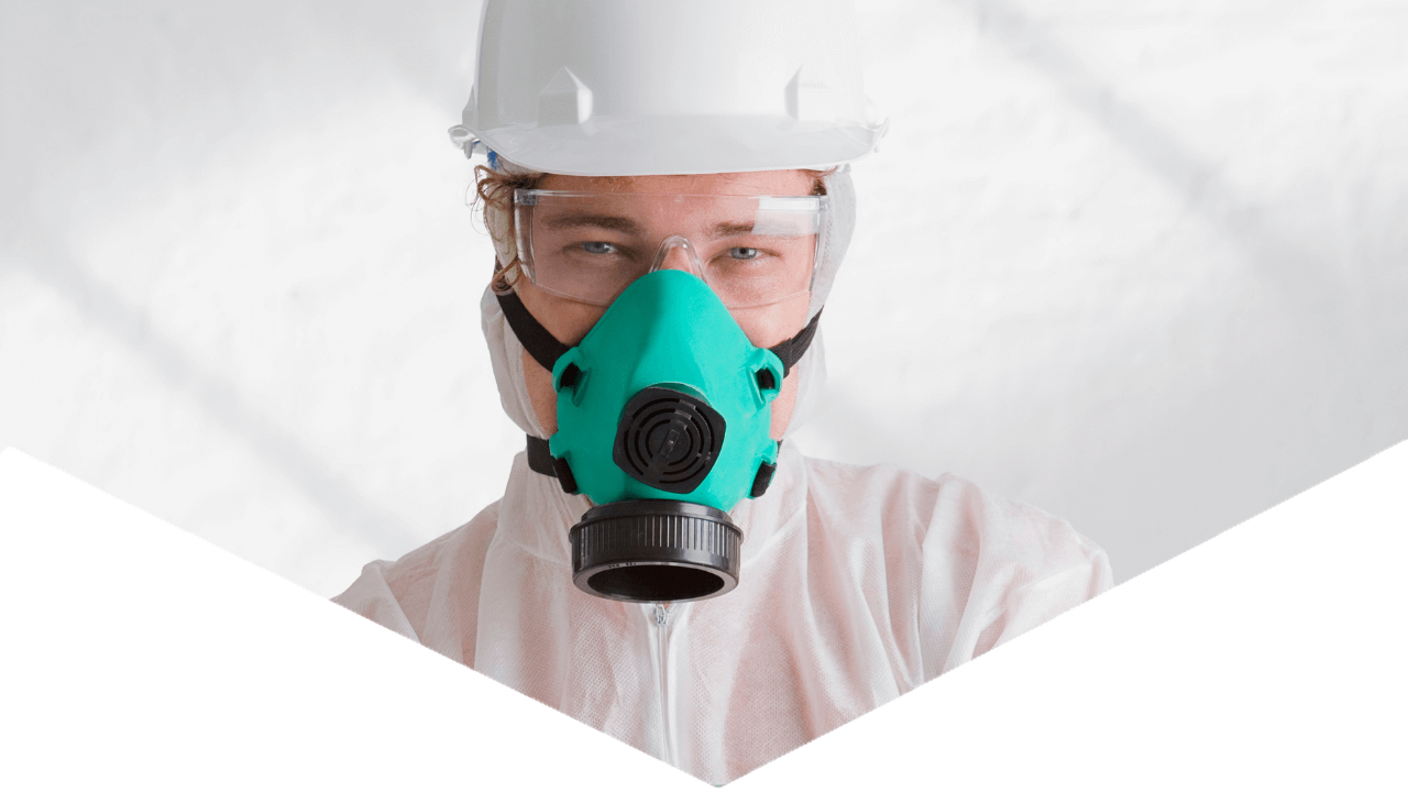 Hero image of Hazmat worker looking at camera with equipment in a triangular shape