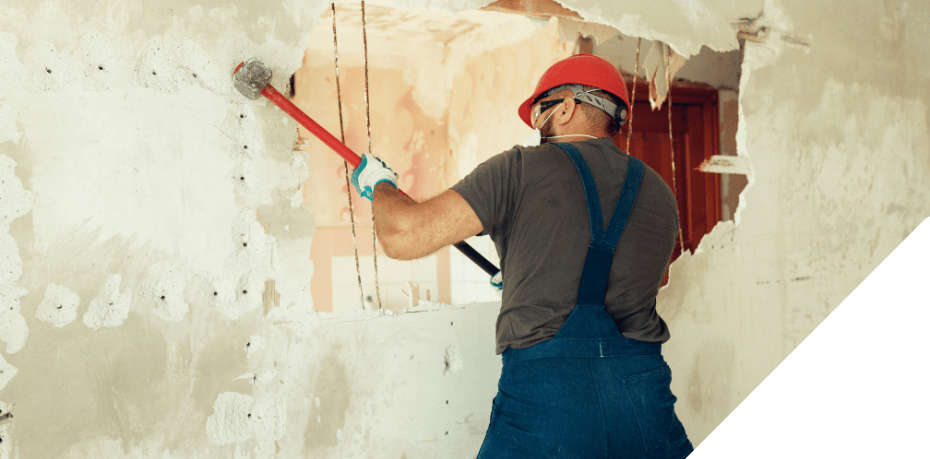 Photo of construction worker taking out a wall