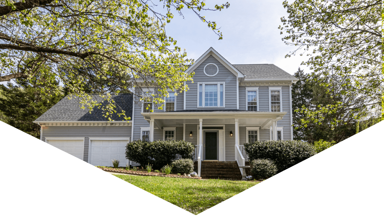 Photo of exterior of home with green trees and blue skies outside 