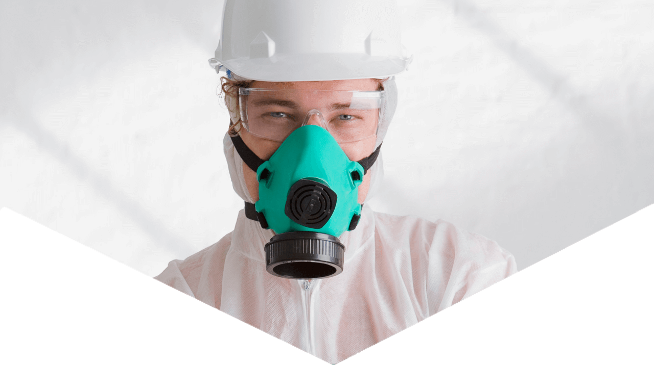 Hero image of Hazmat worker looking at camera with equipment in a triangular shape
