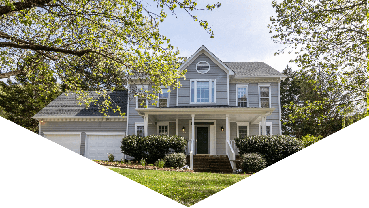 Photo of exterior of home with green trees and blue skies outside